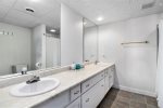 Lower level bathroom with a walk in shower and double vanity